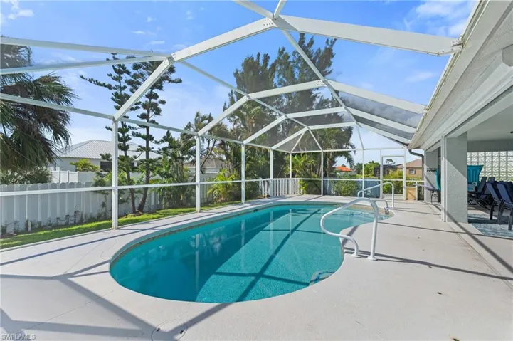 View of pool with a fenced in pool, glass enclosure, fence, and a patio area