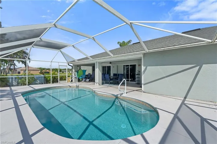 Pool with ceiling fan, a lanai, and a patio area