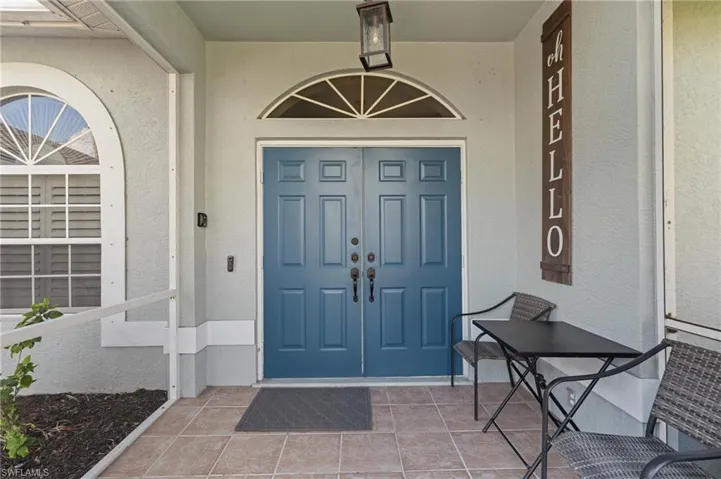 Doorway to property featuring stucco siding