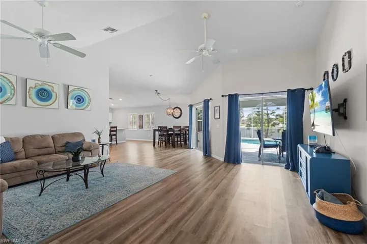 Living room featuring a wealth of natural light, visible vents, and ceiling fan