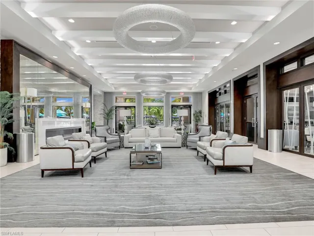Tiled living room featuring beamed ceiling and french doors