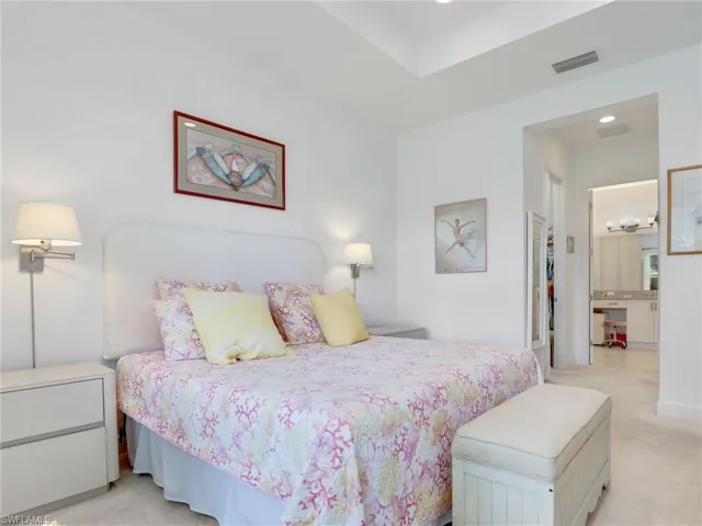 Carpeted bedroom featuring connected bathroom