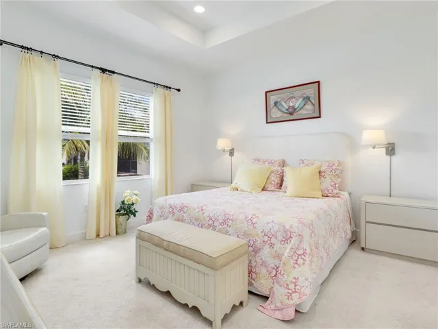 Bedroom featuring multiple windows and carpet flooring