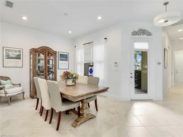 Tiled dining room with a healthy amount of sunlight