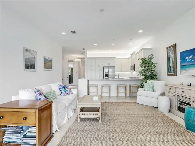 Living room with sink and light tile floors