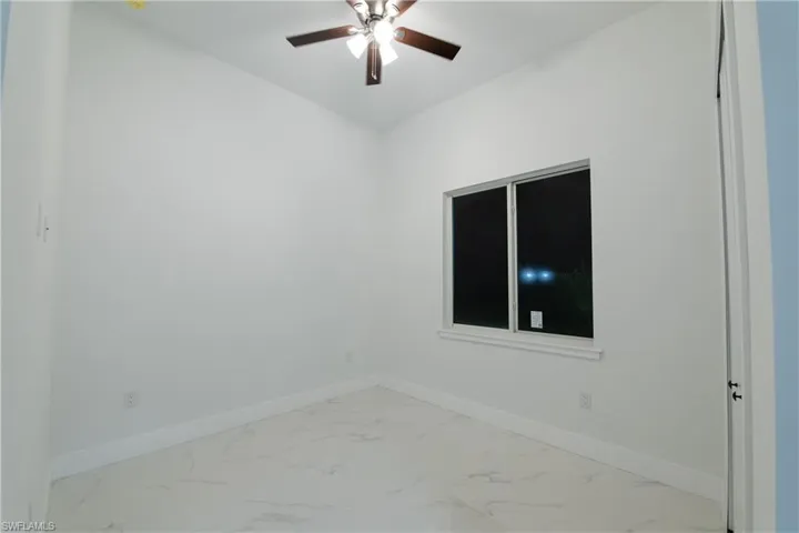 Empty room featuring ceiling fan