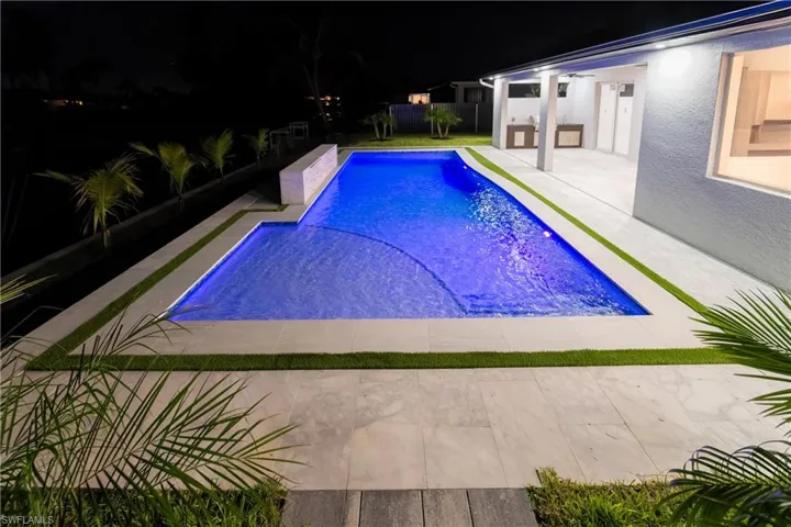 Pool at twilight with a patio