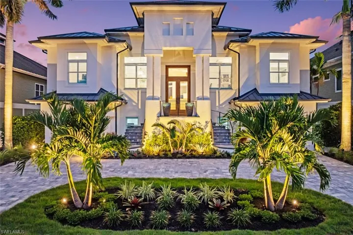 Contemporary home with a standing seam roof, a metal roof, and stucco siding