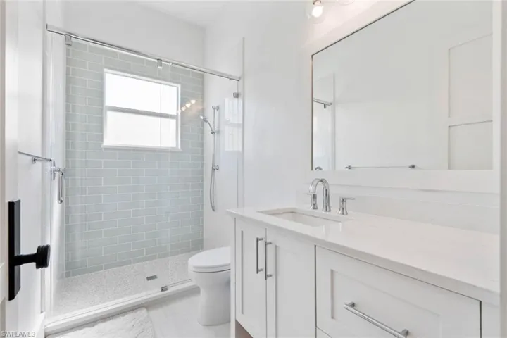 Full bath featuring vanity and a stall shower