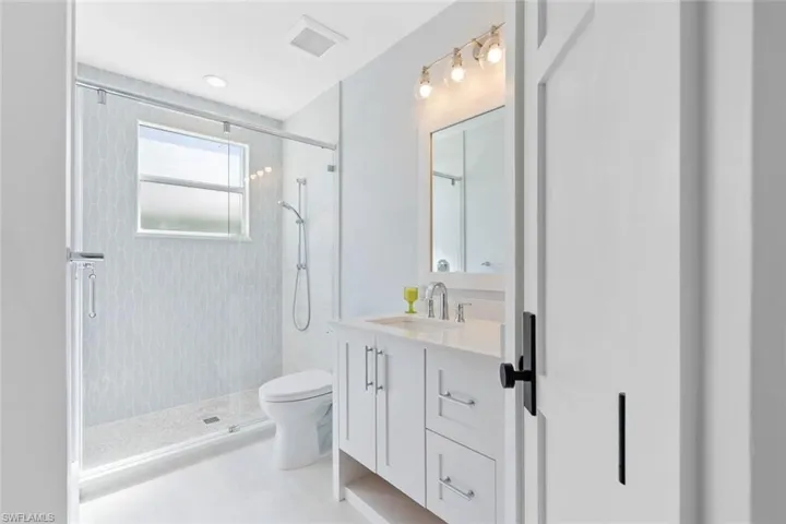 Full bathroom featuring vanity, a stall shower, and recessed lighting