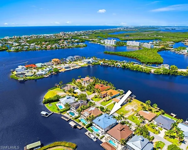Aerial perspective of suburban area featuring a large body of water