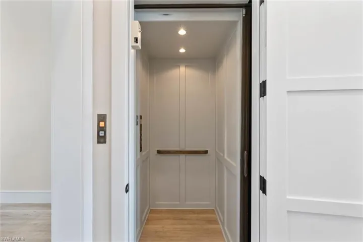 Elevator featuring wood finished floors and recessed lighting