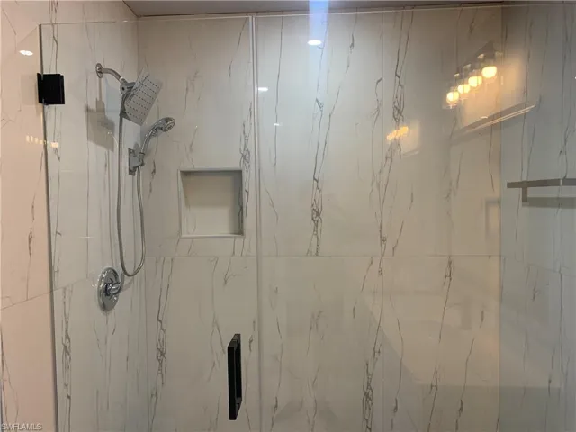 Bathroom featuring a marble finish shower