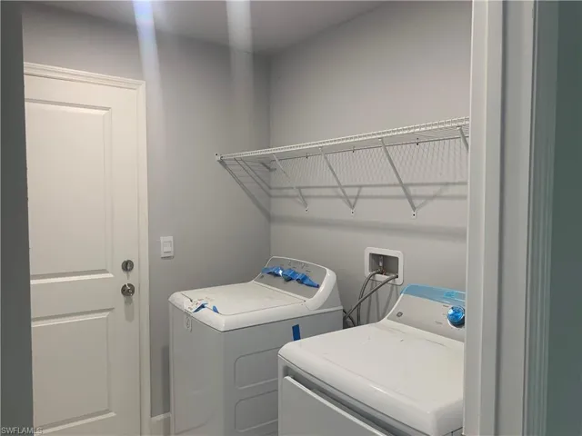 Washroom featuring washing machine and dryer