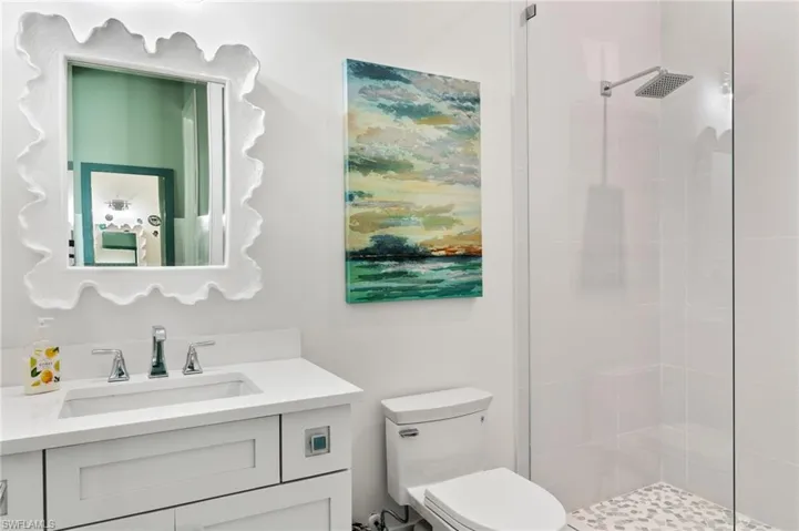 Bathroom featuring vanity and a shower stall