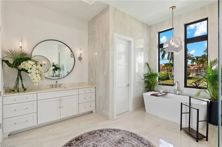 Full bath featuring vanity and a freestanding bath