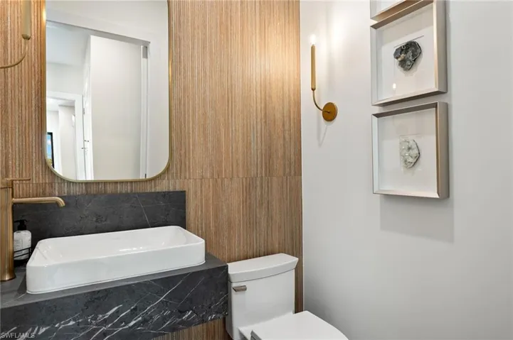 Half bathroom featuring vanity and toilet