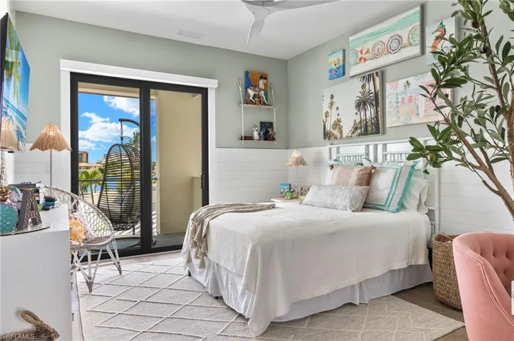 Bedroom with access to outside, wood finished floors, and multiple windows