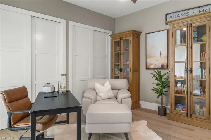 Living area featuring light wood-style floors and baseboards