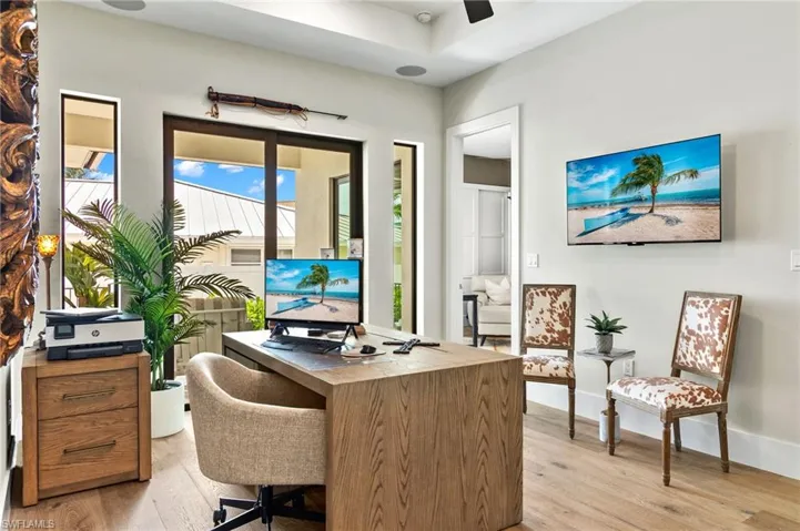 Office with light wood-style flooring and baseboards