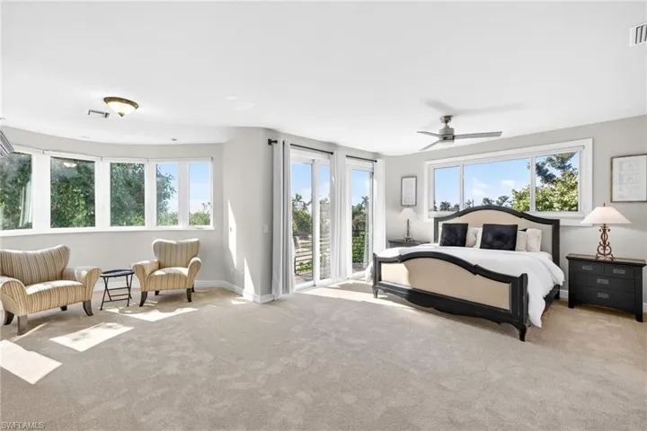 Primary bedroom featuring access to outside and baseboards