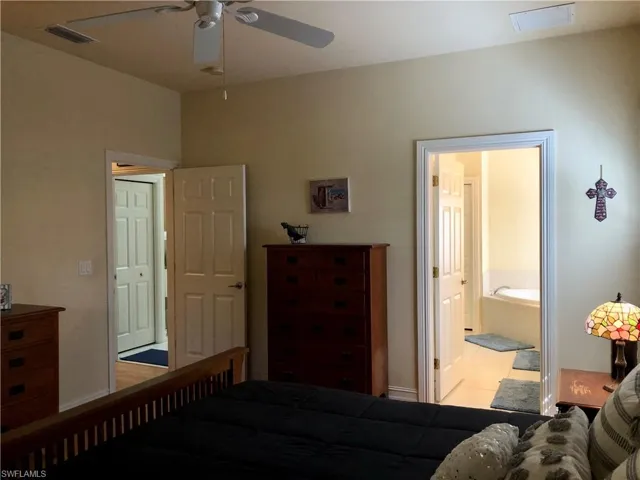 Bedroom with connected bathroom and ceiling fan
