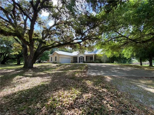 Ranch-style house with a garage and driveway