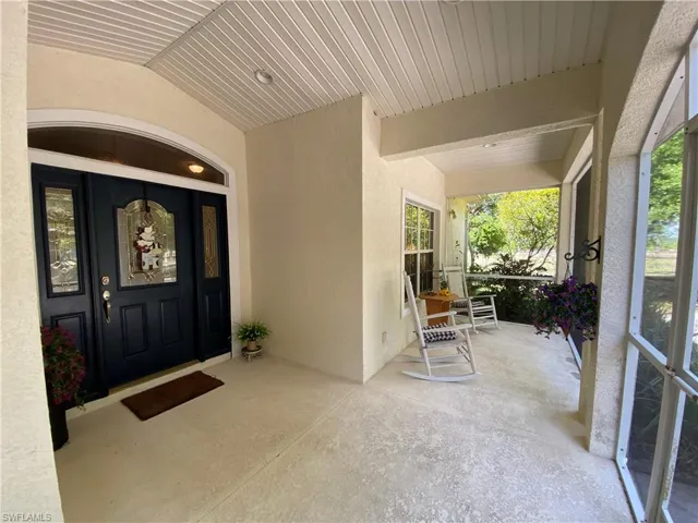 Entrance to property featuring stucco siding