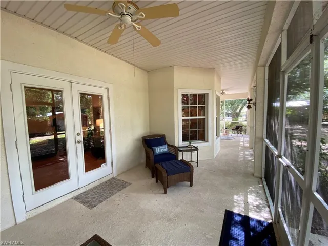 Sunroom / solarium featuring french doors, ceiling fan, and healthy amount of natural light