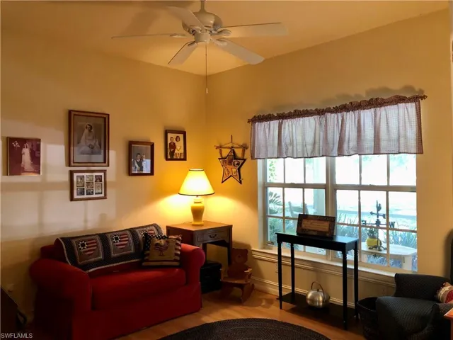 Sitting room with wood finished floors and ceiling fan