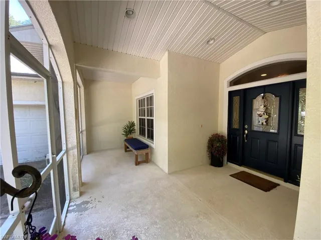 View of exterior entry featuring stucco siding