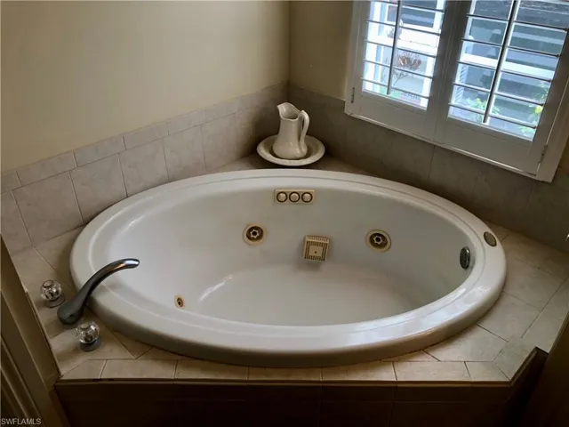 Full bathroom with a whirlpool tub