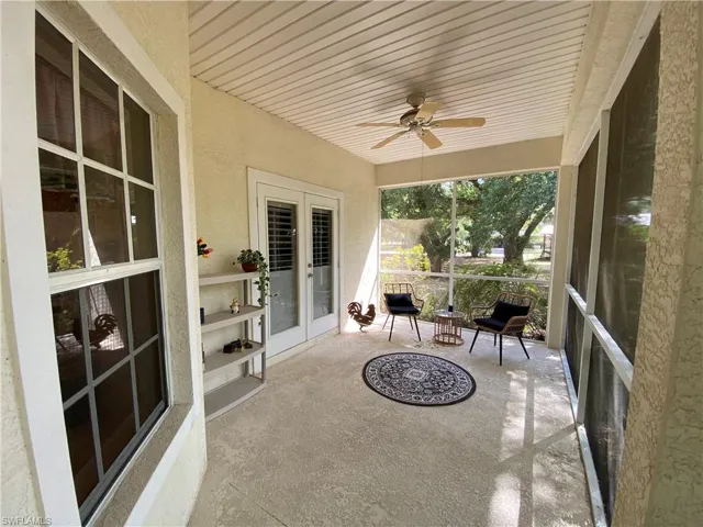 Sunroom / solarium with french doors and ceiling fan