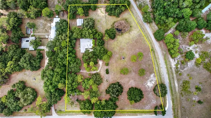 Expansive aerial showcasing a significant land parcel with multiple structures
