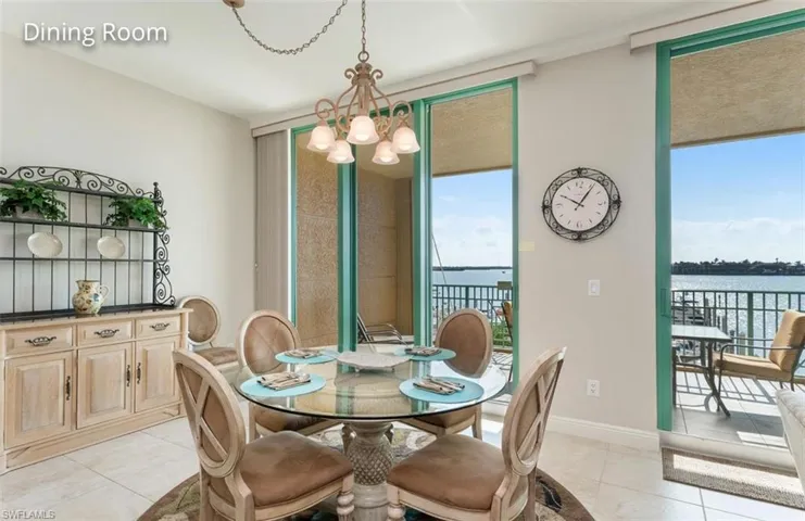 Dining area featuring plenty of natural light, a notable chandelier, baseboards, and light tile patterned floors