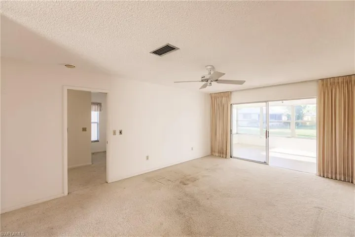 Living Room, Sliders to the Florida Room & Entrance to Master Bedroom & Bath