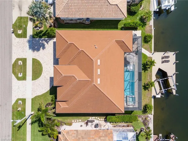 Birds eye view of property with a water view