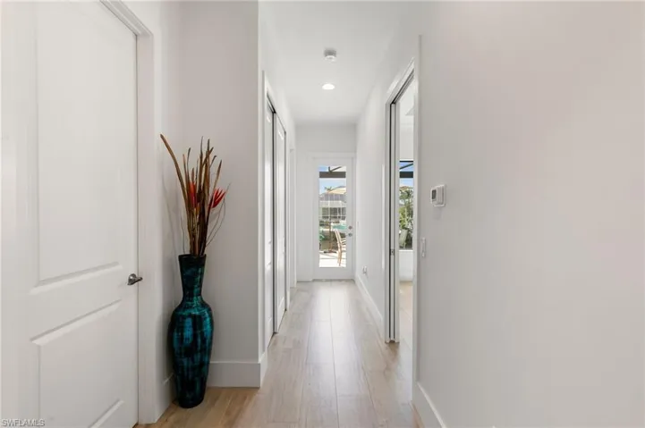 Hall featuring light wood-style floors, recessed lighting, and baseboards