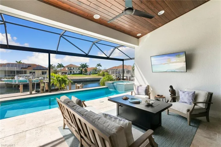View of swimming pool with an outdoor hangout area, a patio, a lanai, and a ceiling fan