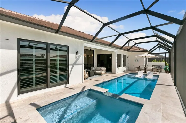 View of swimming pool with a pool with connected hot tub, a patio, and an outdoor hangout area