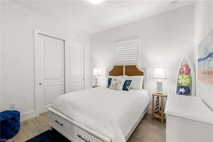 Bedroom featuring a closet, light wood-type flooring, and baseboards