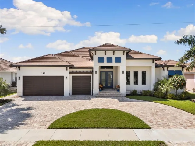 View of front of house with a garage, french doors, decorative driveway, and stucco siding