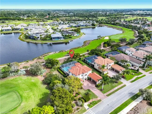 View of property location featuring nearby suburban area, a golf course, and a nearby body of water