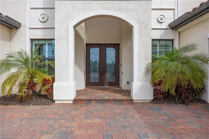 Property entrance featuring french doors and stucco siding