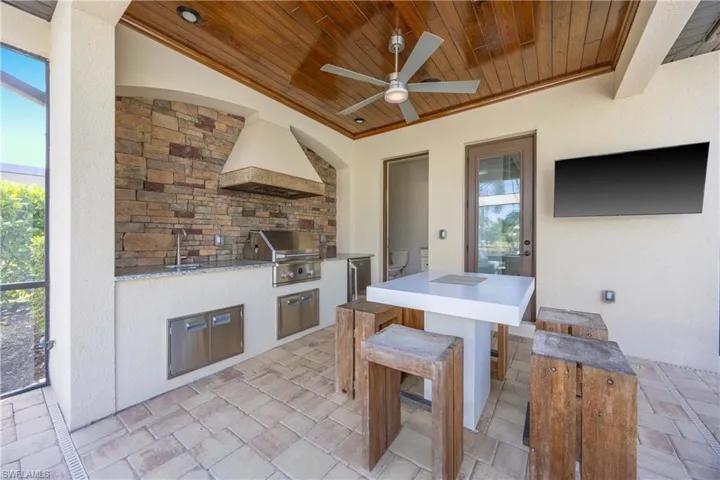 View of patio featuring an outdoor kitchen and a ceiling fan