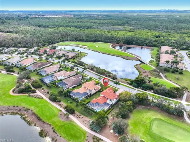Aerial view of property and surrounding area with a large body of water and nearby suburban area