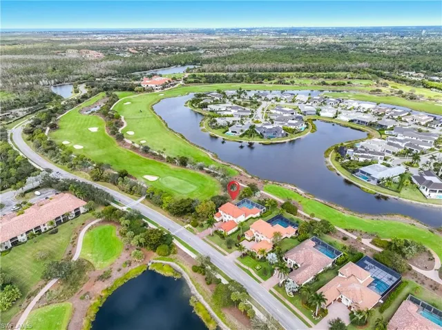 View of property location featuring a large body of water and nearby suburban area