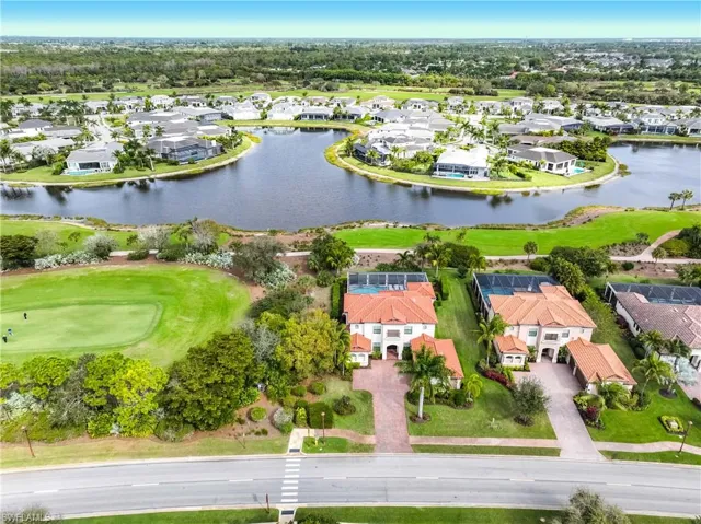 View of property location with nearby suburban area, a large body of water, and a golf course