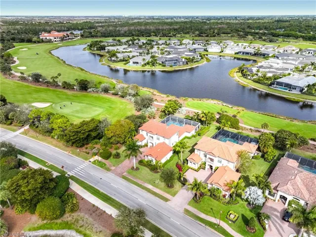 View of property location with nearby suburban area, a large body of water, and a golf course