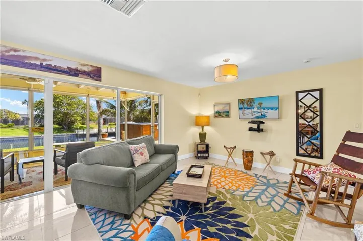 Living area featuring visible vents, baseboards, tile patterned floors, and plenty of natural light